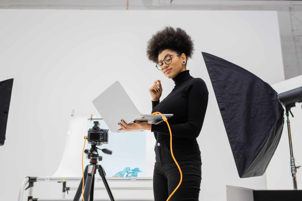 african-american-content-maker-with-laptop-smiling-PN293K3.jpg